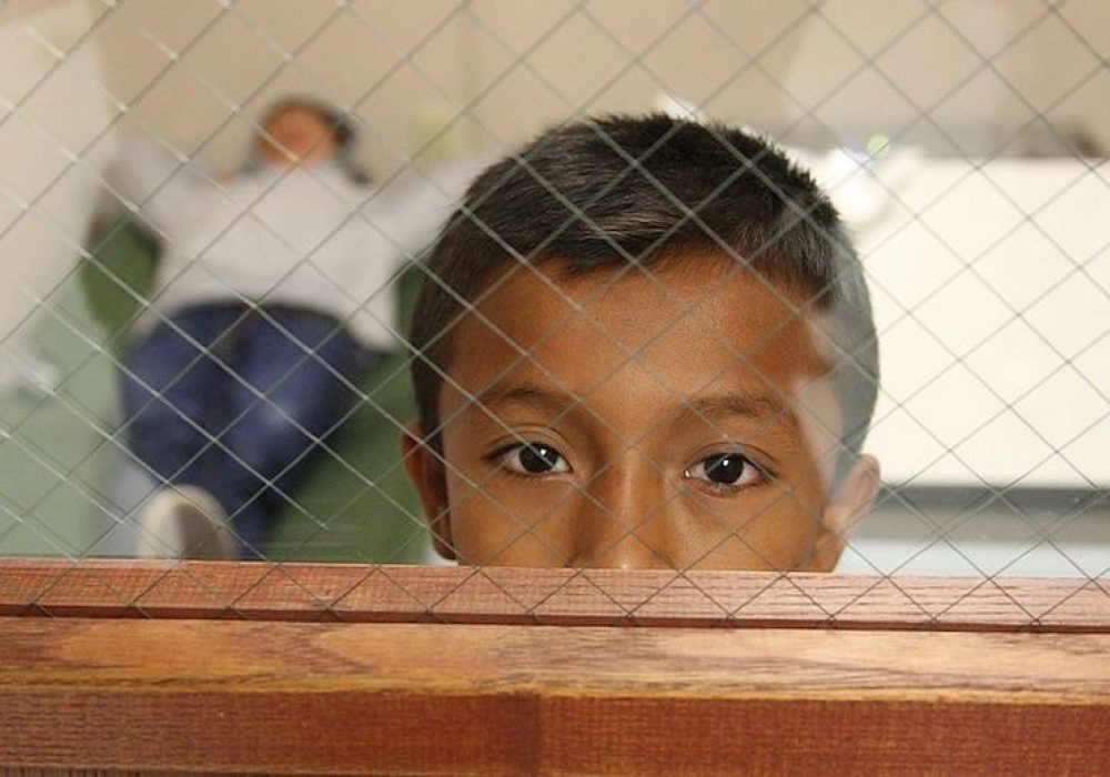 Child at a U.S. Customs and Border Protection facility, 2014. CREDIT: <a href="https://commons.wikimedia.org/wiki/File:CBP_Processing_Unaccompanied_Children_(15020197208).jpg"> Eddie Perez</a> , U.S. Customs & Border Protection, public domain