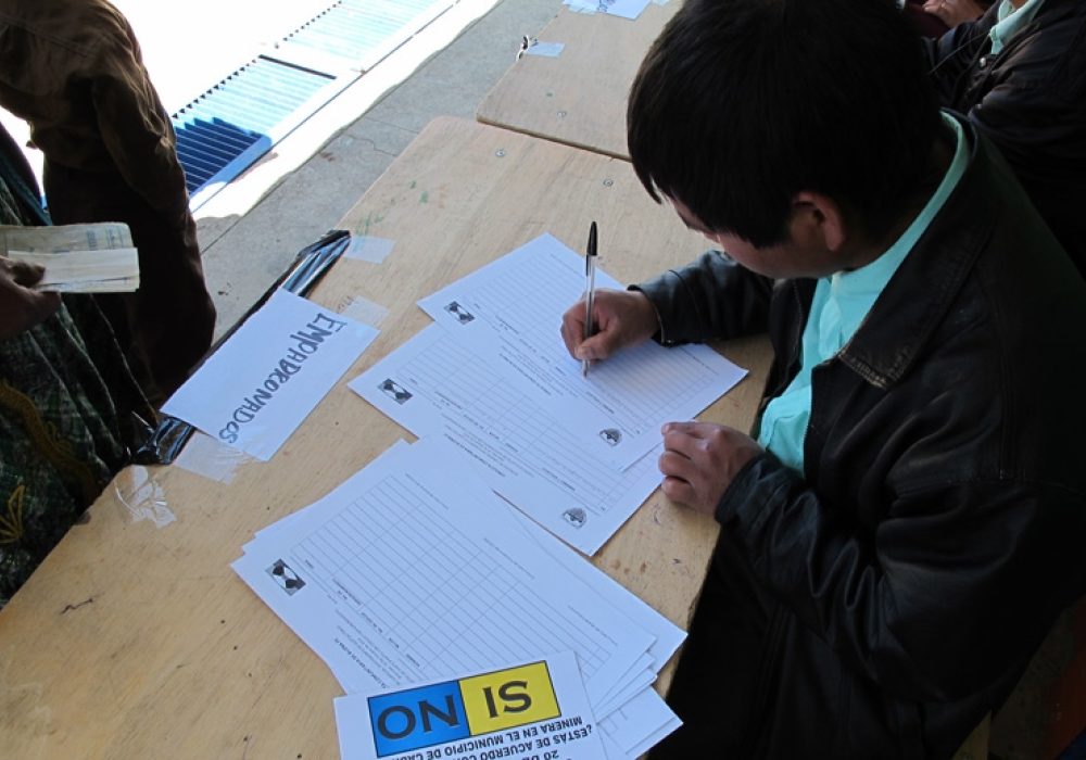 A community poll worker in Cabrican, Guatemala records the names of participants in the referendum and hands out ballots, October 2010. CREDIT: Katherine Fultz