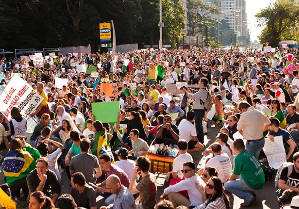 Protesters in Sao Paulo in June 2013 via <a href="http://www.shutterstock.com/pic-190374902/stock-photo-sao-paulo-brazil-june-some-protesters-marching-on-paulista-avenue-holding-signs-with.html?src=9bHtQcDaZEdt6k_Tqv-RUw-1-12">Shutterstock</a>