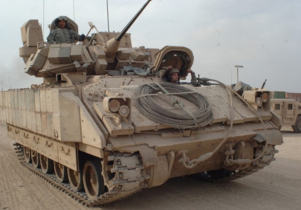 U.S. Army Soldiers drive a Bradley Fighting Vehicle in East Baghdad, Iraq (2007).<br>CREDIT: <a href="https://www.flickr.com/photos/soldiersmediacenter/421323075/">The U.S. Army</a> (<a href="https://creativecommons.org/licenses/by/2.0/">CC</a>)