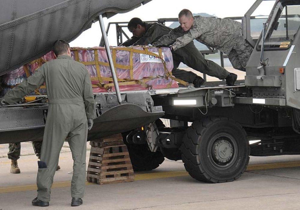 U.S. servicemembers load humanitarian relief supplies for victims of Cyclone Nargis. Yokota Air Base, Japan, 2008. CREDIT: <a href=https://commons.wikimedia.org/wiki/File:080512-F-1590C-553_Loading_relief_supplies_at_U-Tapao.jpg>U.S. Air Force (CC)</a>.