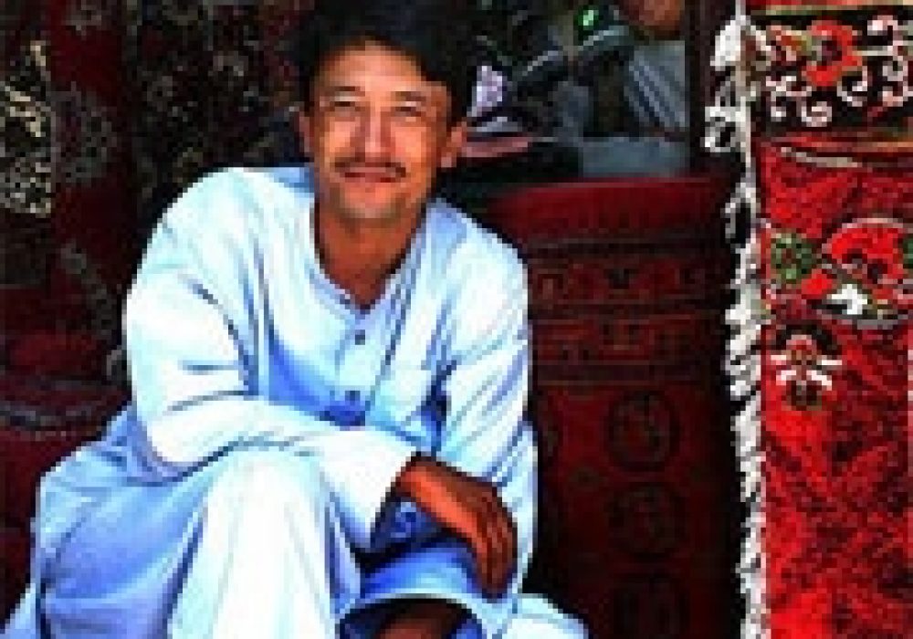 Carpet vendor in Kabul, Afghanistan <br>(2005). Photo by <a href="http://flickr.com/photos/babasteve/25456049/">Steve Evans</a> (<a href="http://creativecommons.org/licenses/by/2.0/deed.en-us">CC</a>).