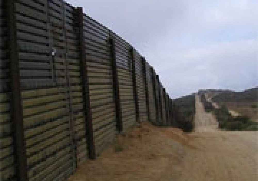 Fence along the U.S.-Mexico border. <br>Photo by <a href="http://www.flickr.com/photos/16216900@N00/174045778/" target=_blank>Edmond Meinfelder</a> (<a href="http://creativecommons.org/licenses/by/2.0/deed.en-us" target=_blank>CC</a>).