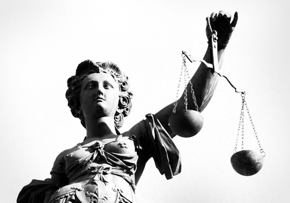 Image via <a href="http://www.shutterstock.com/pic-114542110/stock-photo-justice-statue-in-black-and-white.html">Shutterstock</a>