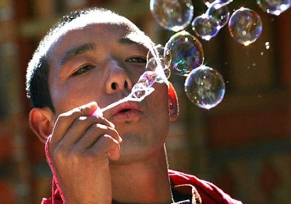 Bhutanese monk blowing bubbles. CREDIT: <a href="http://flickr.com/photos/babasteve/2249740073/">Steve Evans</a> (<a href="http://creativecommons.org/licenses/by/2.0/deed.en">CC</a>).
