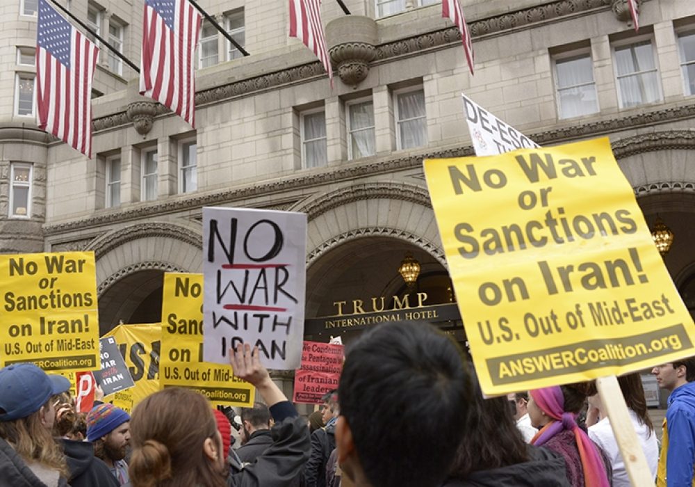Protesters at Trump International Hotel in Washington, DC after the drone strike that killed Soleimani. CREDIT: <a href=https://www.flickr.com/photos/stephenmelkisethian/49329666788/>Stephen Melkisethian (CC)</a>.