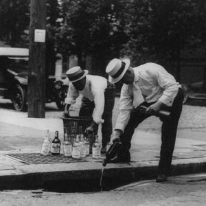 Pouring whiskey into a sewer, 1921. CREDIT: <a href"=https://www.loc.gov/item/2001706109/">Library of Congress</a>