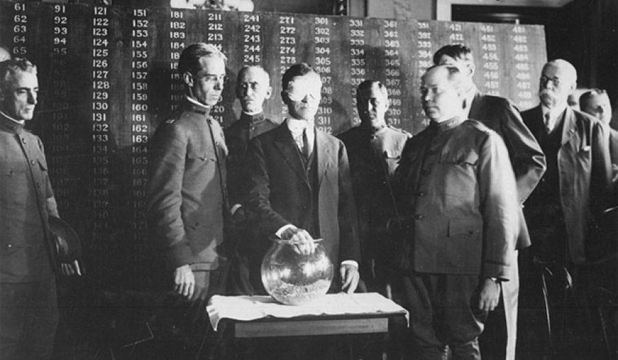 July 1917: U.S. Secretary of War, blindfolded, draws the first number in the draft lottery.