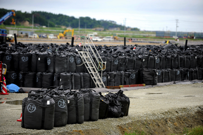 Photo: Allison Kwesell. Bags of radiated top soil being collected.