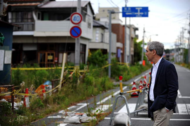 Photo: Allison Kwesell. Michael Ignatieff examines damage in Fukushima, Japan.