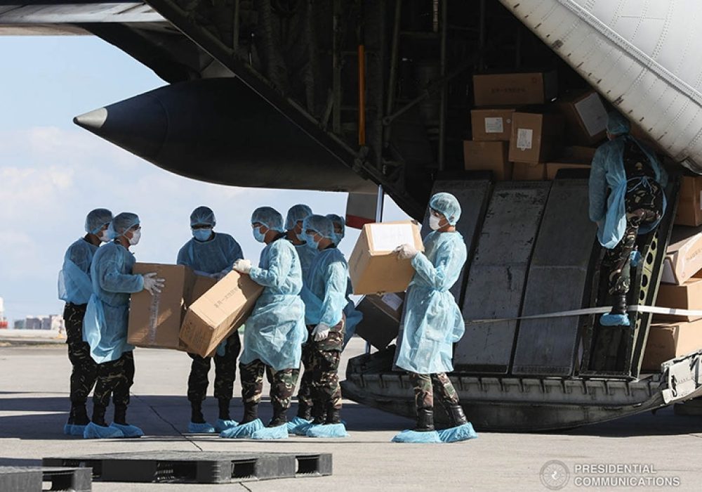 Aid packages from China are unloaded at the Villamor Air Base in Pasay City, Philippines on March 21, 2020. CREDIT: <a href=https://commons.wikimedia.org/wiki/File:China_COVID19_test_kit_PH_donation_7.jpg> Philippines Presidential Communications Operations Office (CC)</a>.