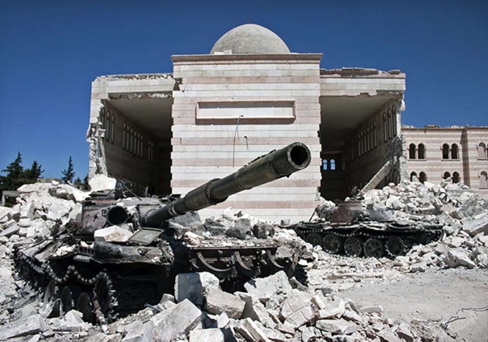 Destroyed tank and mosque in Azaz, Syria via <a href="http://www.shutterstock.com/pic-161912165/stock-photo-azaz-syria-august-a-destroyed-tank-in-front-of-a-similarly-ruined-mosque.html">Shutterstock</a>
