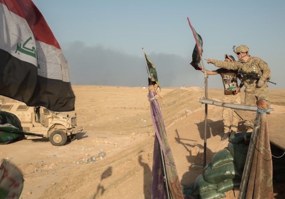 U.S. and Iraqi soldier near Mosul, October, 2016. CREDIT: <a href="https://commons.wikimedia.org/wiki/File:U.S._Soldier_prepares_for_key_leader_engagement_to_assess_Iraqi_security_force_checkpoints_at_Q-West.jpg">Spc. Christopher Brecht/U.S. Army</a>