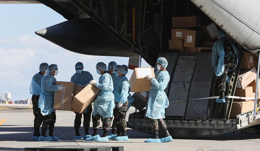 Aid packages from China are unloaded at the Villamor Air Base in Pasay City, Philippines on March 21, 2020. CREDIT: <a href=https://commons.wikimedia.org/wiki/File:China_COVID19_test_kit_PH_donation_7.jpg> Philippines Presidential Communications Operations Office (CC)</a>.