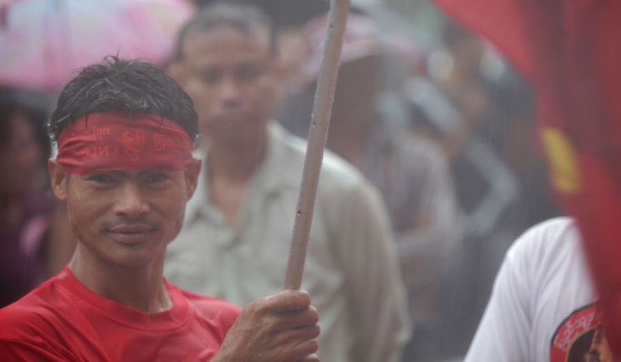 A supporter of Aung San Suu Kyi's National League for Democracy on Electioon Day, 2015, Rangoon, Myanmar. CREDIT: Van Royko