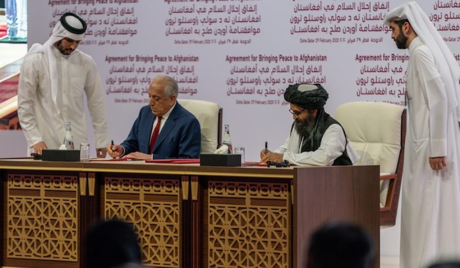 U.S. representative Zalmay Khalilzad (left) and Taliban representative Abdul Ghani Baradar (right) sign the Agreement for Bringing Peace to Afghanistan in Doha, Qatar on February 29, 2020. CREDIT: <a href="https://en.wikipedia.org/wiki/War_in_Afghanistan_(2001–present)#/media/File:Secretary_Pompeo_Participates_in_a_Signing_Ceremony_in_Doha_(49601220548).jpg">U.S. Department of State/Public Domain</a>